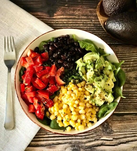 Salad with avocado, corn, bell peppers, and black beans.