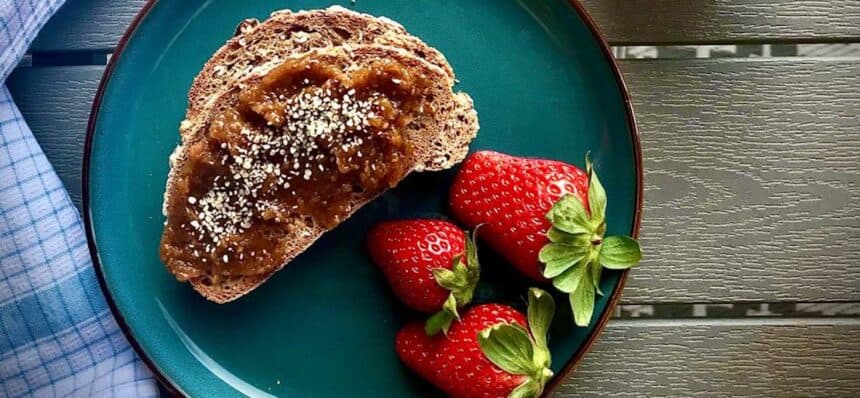 Closeup of toast with apricot chia jam and strawberries.