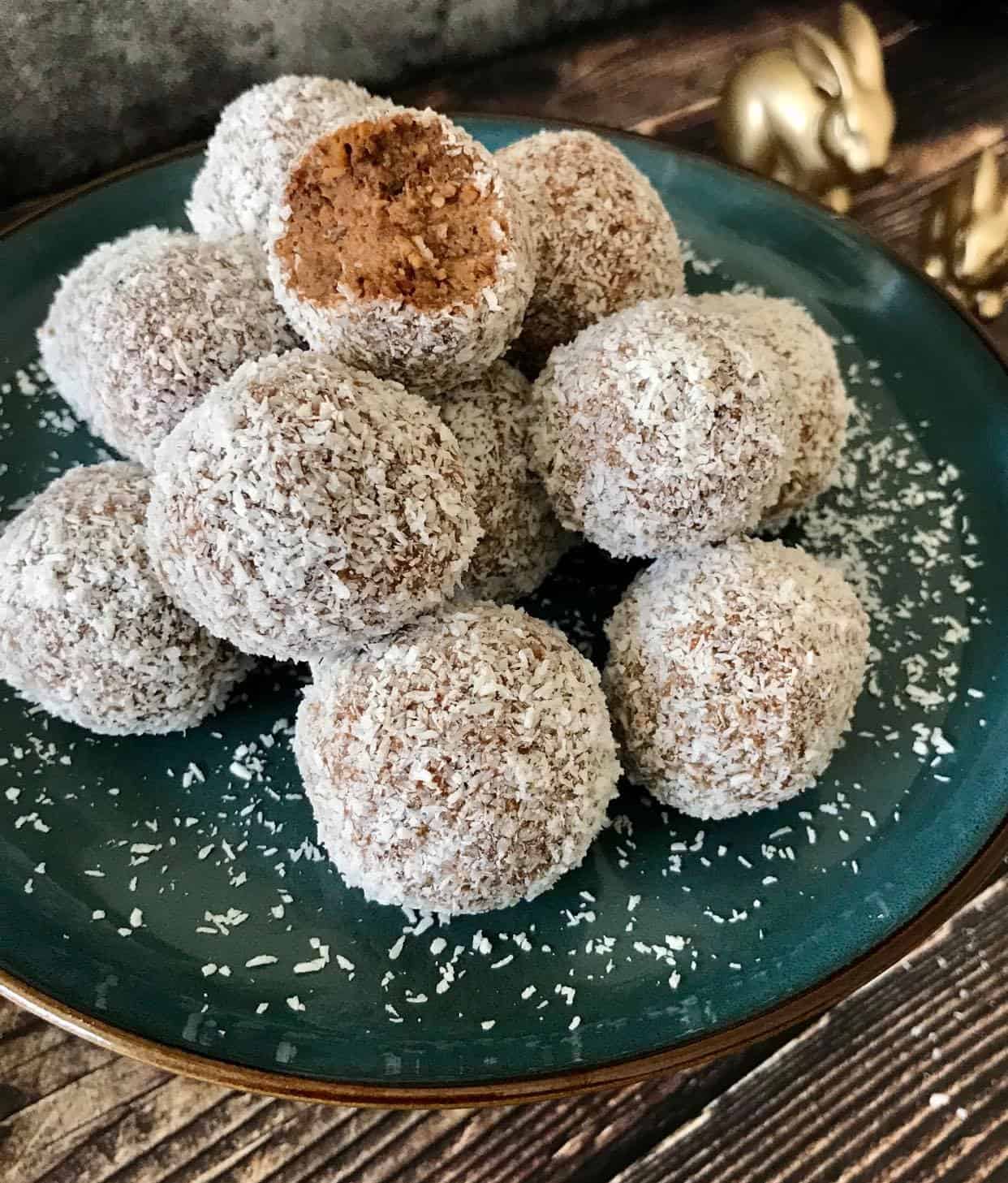 No-bake carrot cake bites on a plate with two bunny figurines.