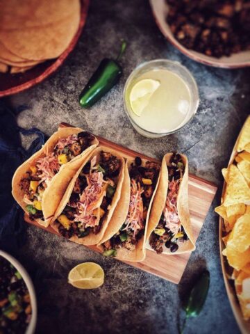 Vegan fish tacos on a cutting board.