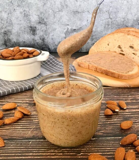 Spoon dipped in almond butter.