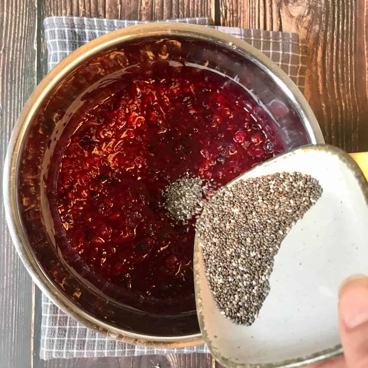 Adding chia seeds to berry mash.