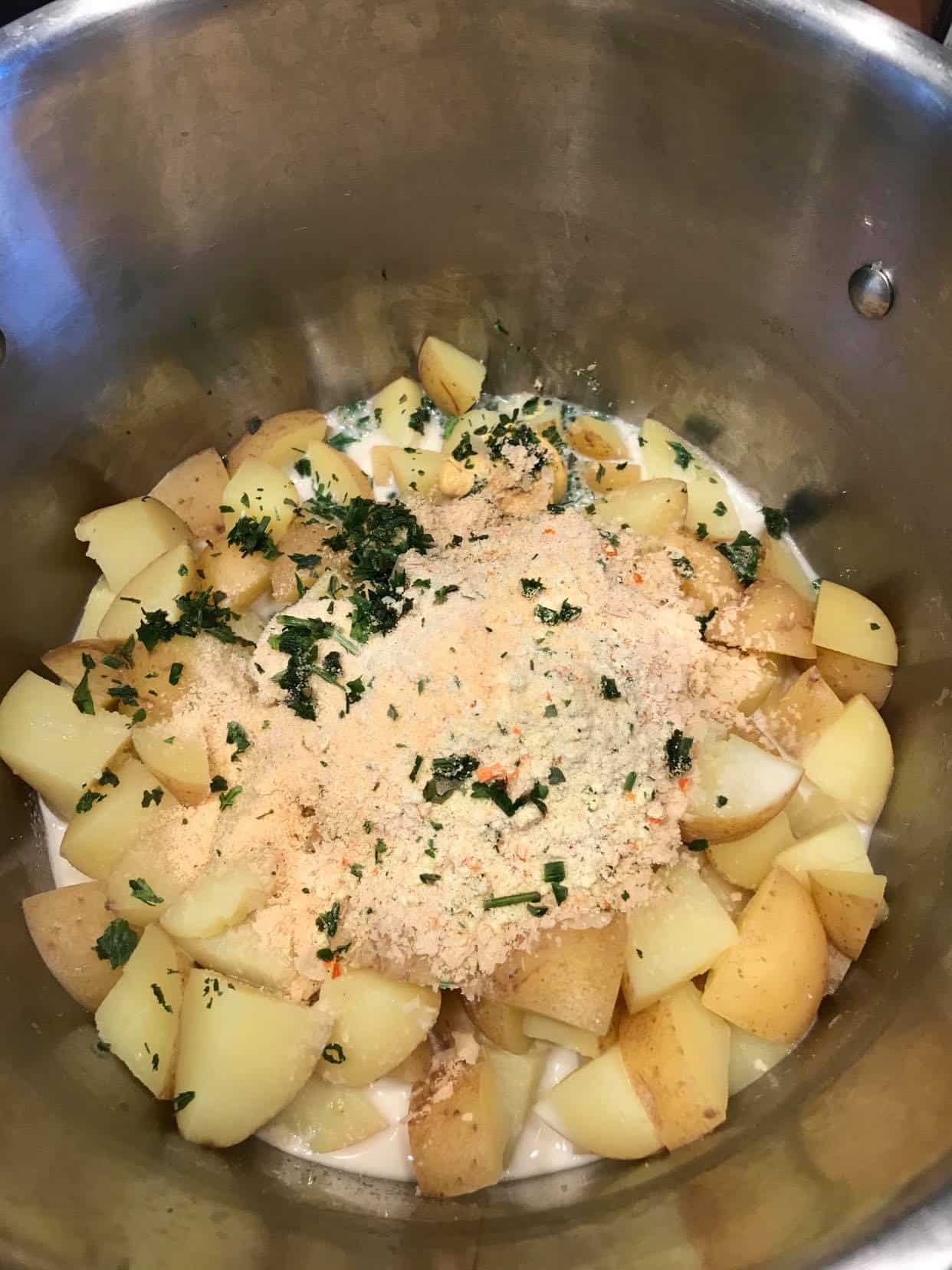 Cooked potatoes and ingredients in a pot.