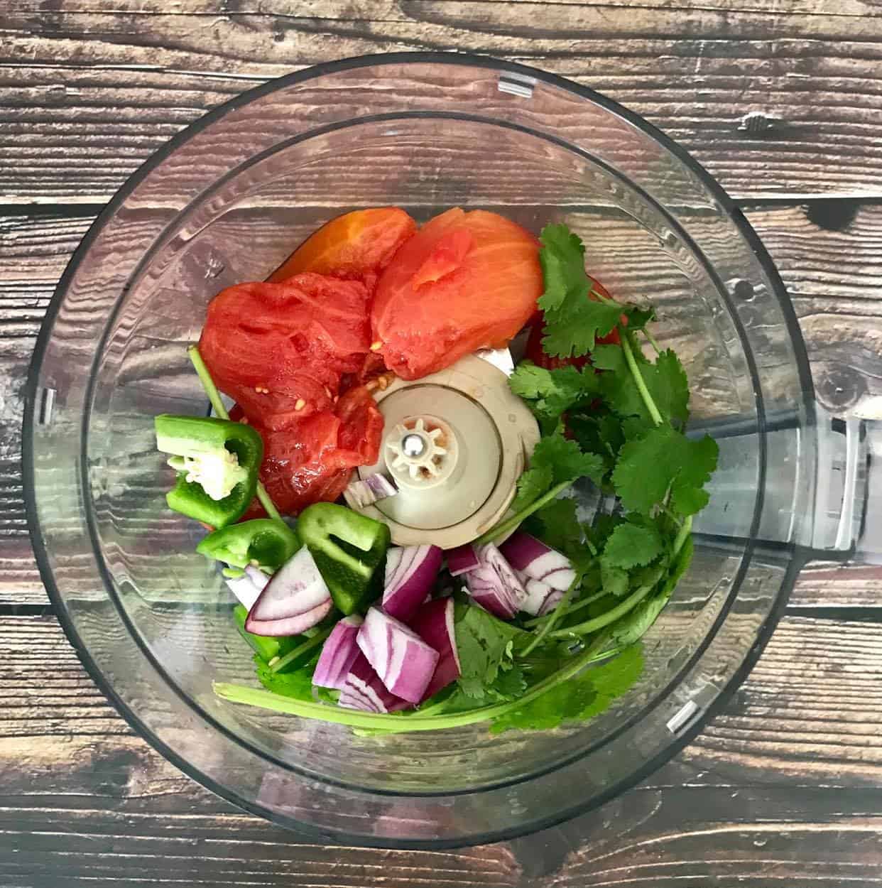 Tomatoes, jalapeno, onion, and cilantro in a food processor.