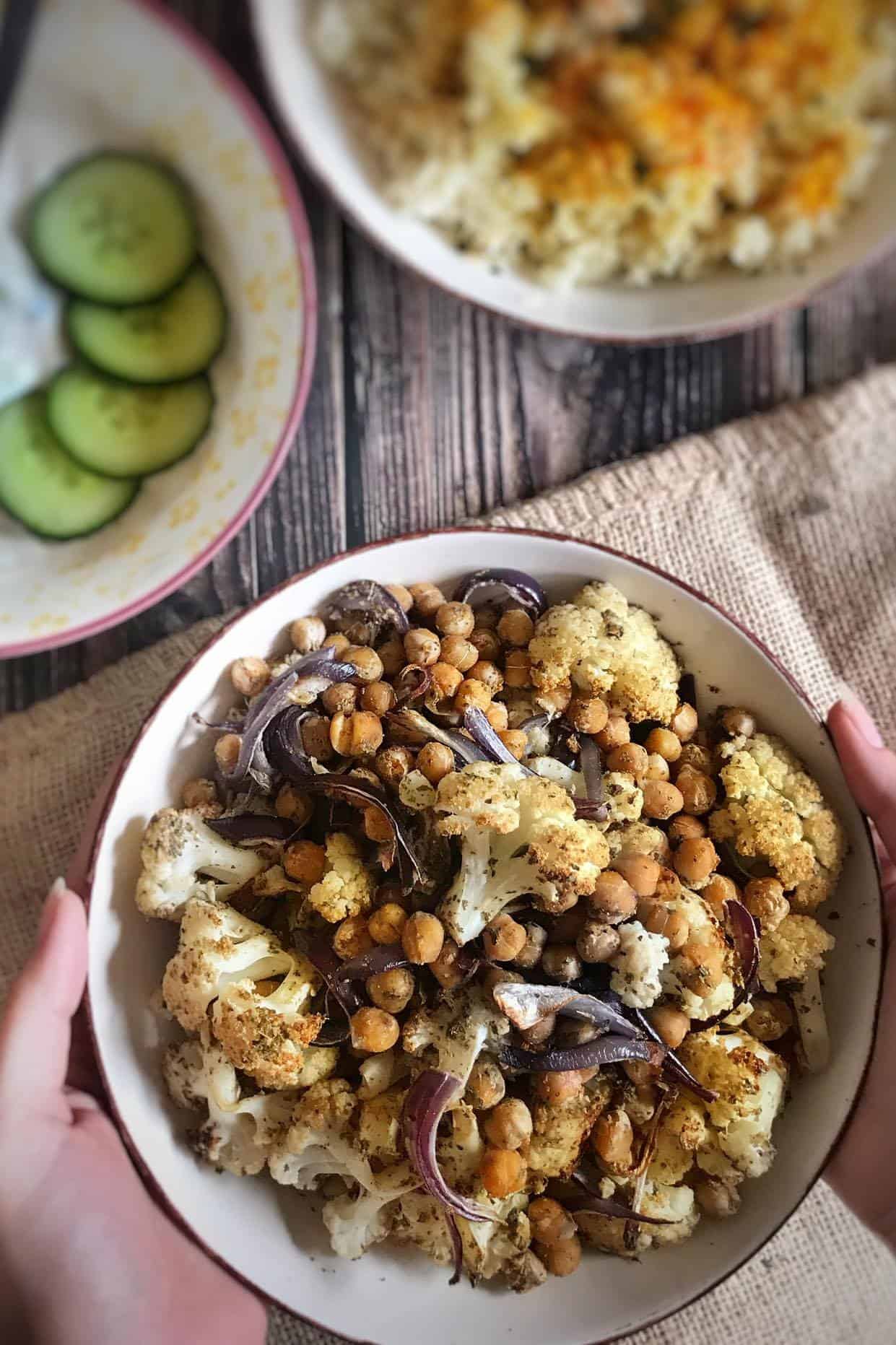 Roasted Cauliflower and Chickpeas in a bowl with couscous and vegan tzatziki.