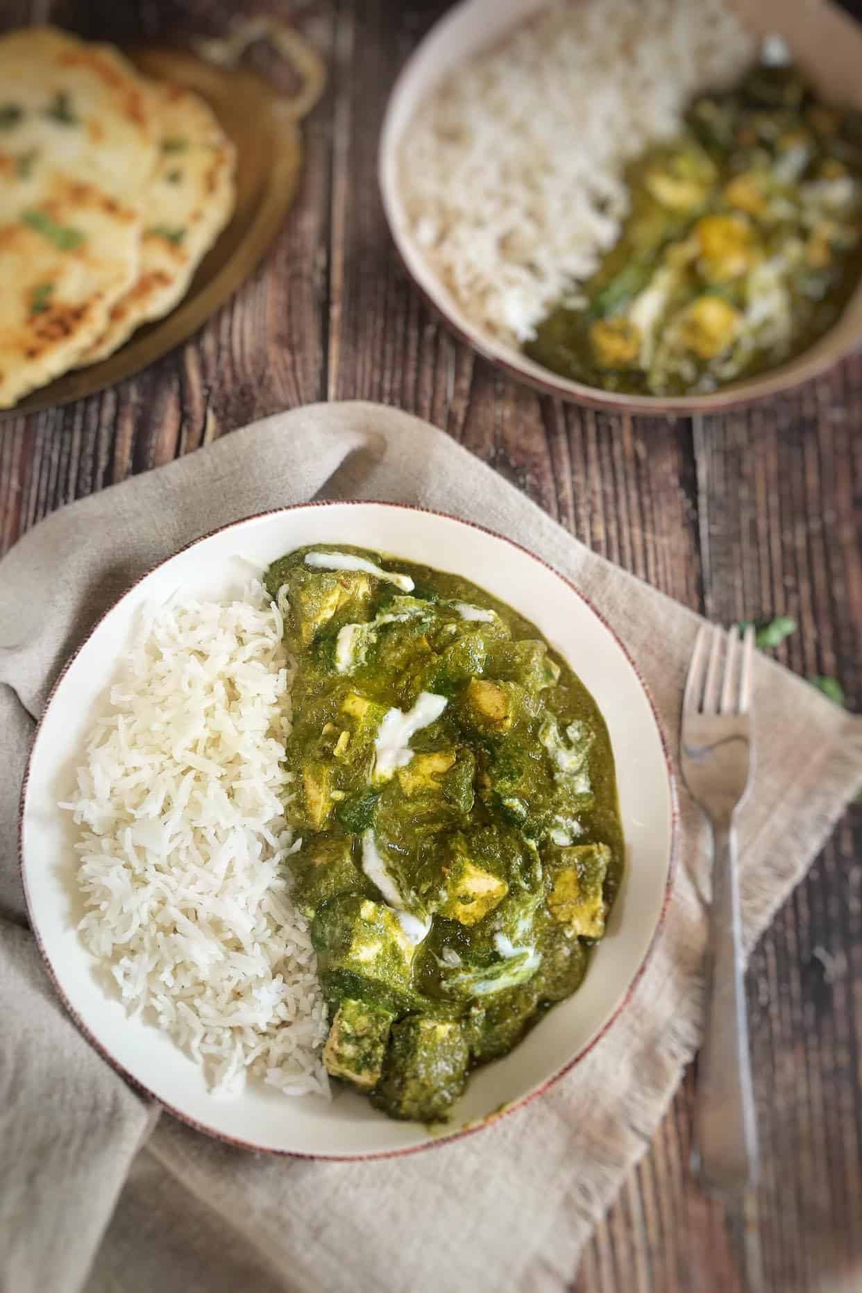 Bowl of vegan palak paneer and rice.