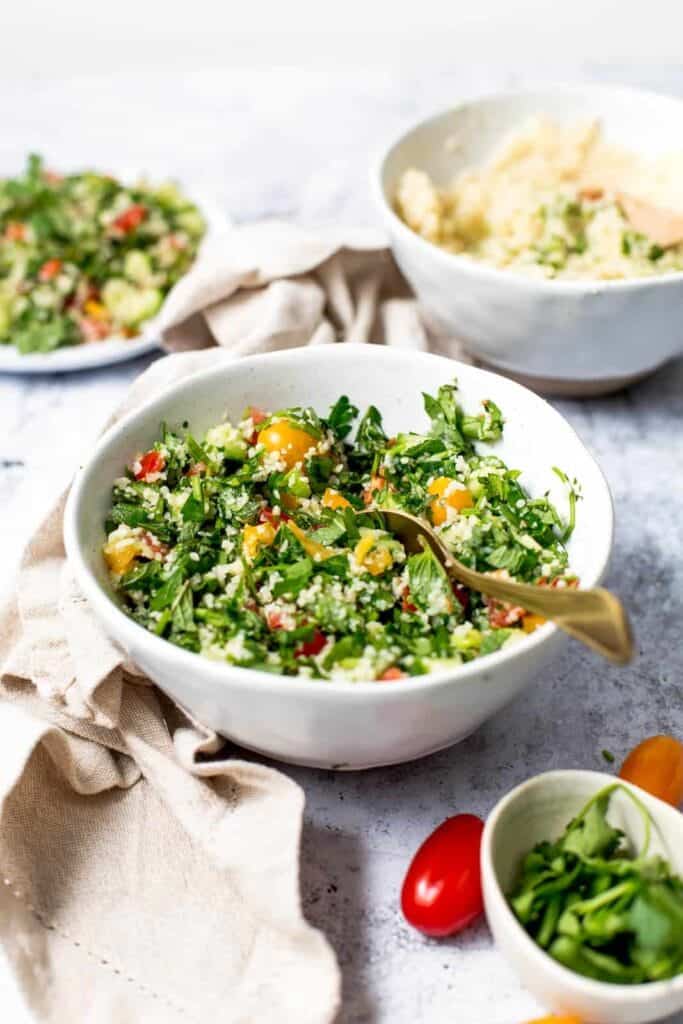 Tabbouleh salad in a bowl with a spoon.