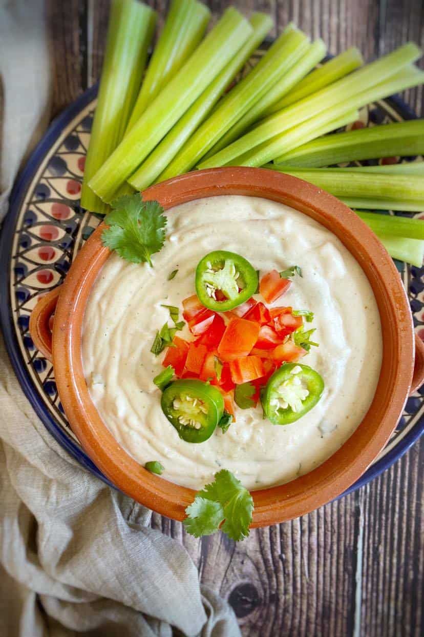 Cashew queso on a plate with celery.