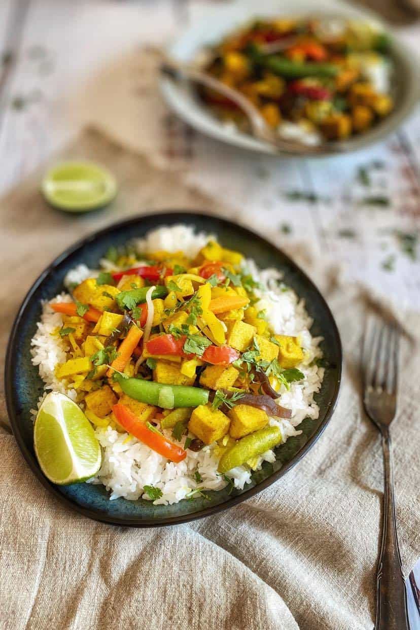 Vegan yellow Thai curry in a bowl over rice.