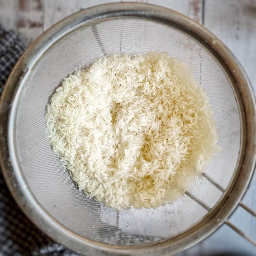 Rinse the rice under cold water in a fine mesh strainer.