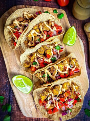 Vegan tofu tacos on a cutting board.