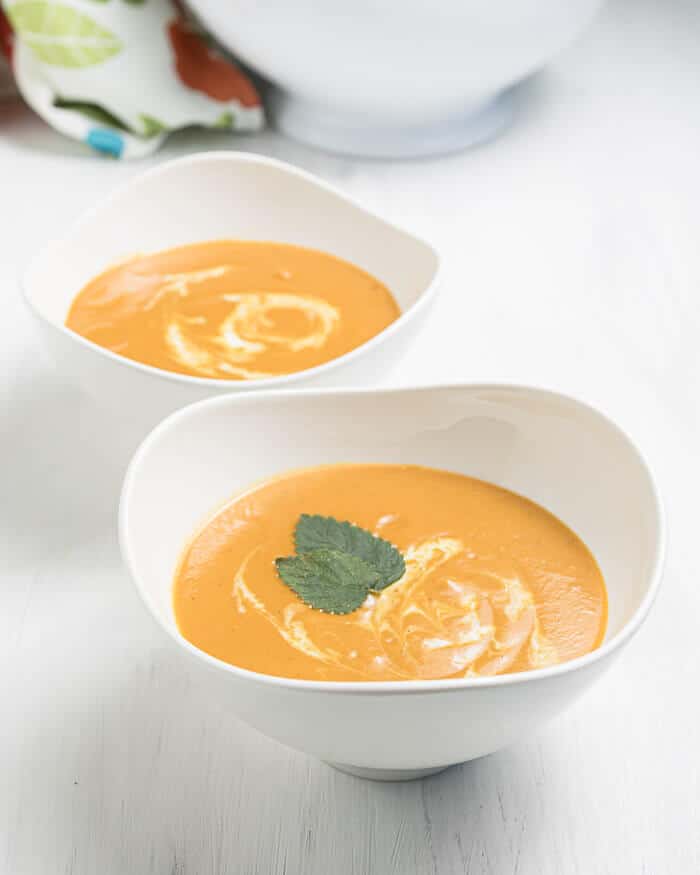 Vegan carrot soup in two bowls.