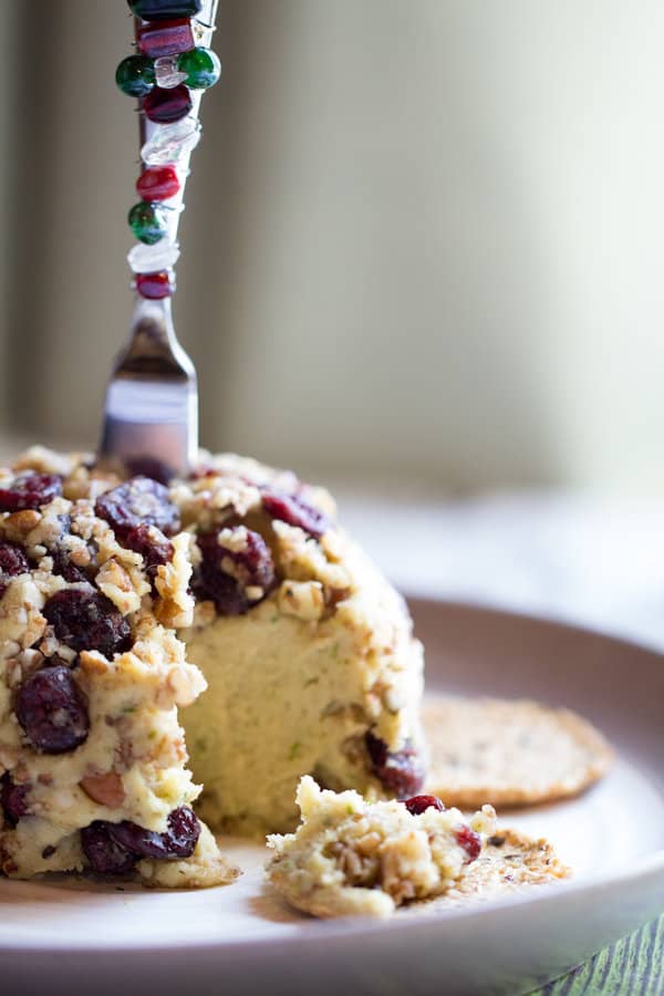 Vegan cranberry cheese ball with a fork stuck in the top.