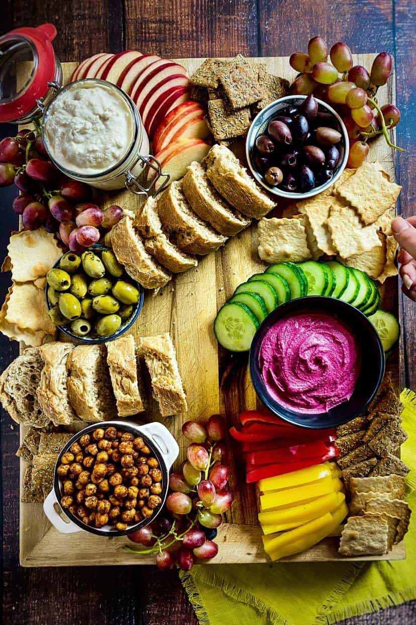 Bread and crackers added to a vegan charcuterie board.