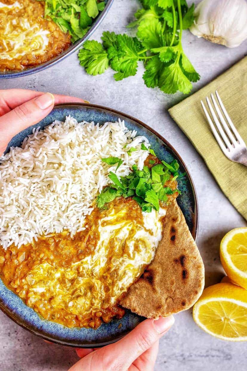 Red lentil dahl in a bowl with rice.