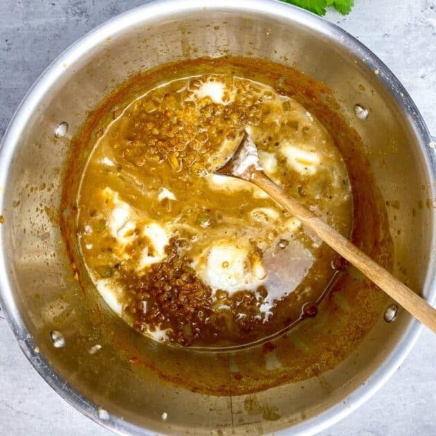 Coconut milk added to the dal in the pot.