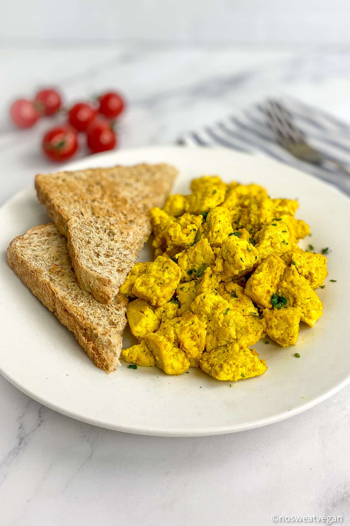 Tofu scramble on a plate with toast.