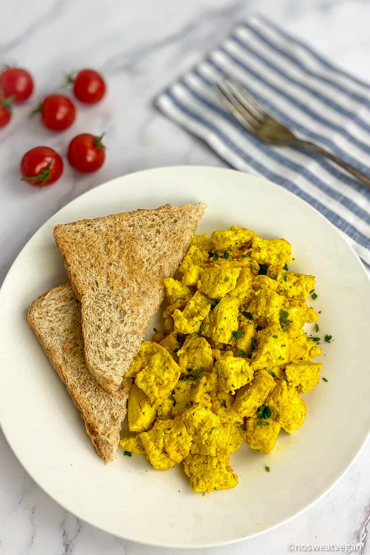 Scrambled tofu on a plate with toast.