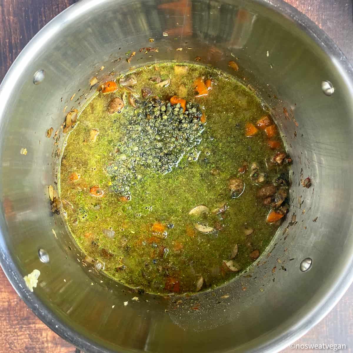 Lentils and vegetable broth added to the pot.