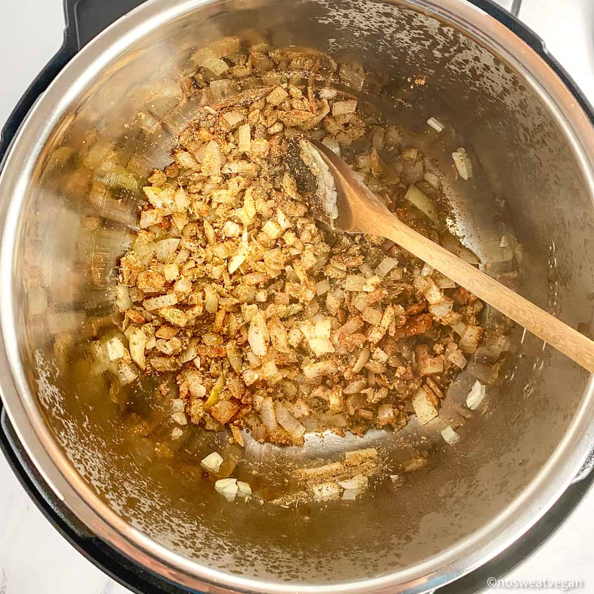 Onions and spices cooking in an Instant Pot.