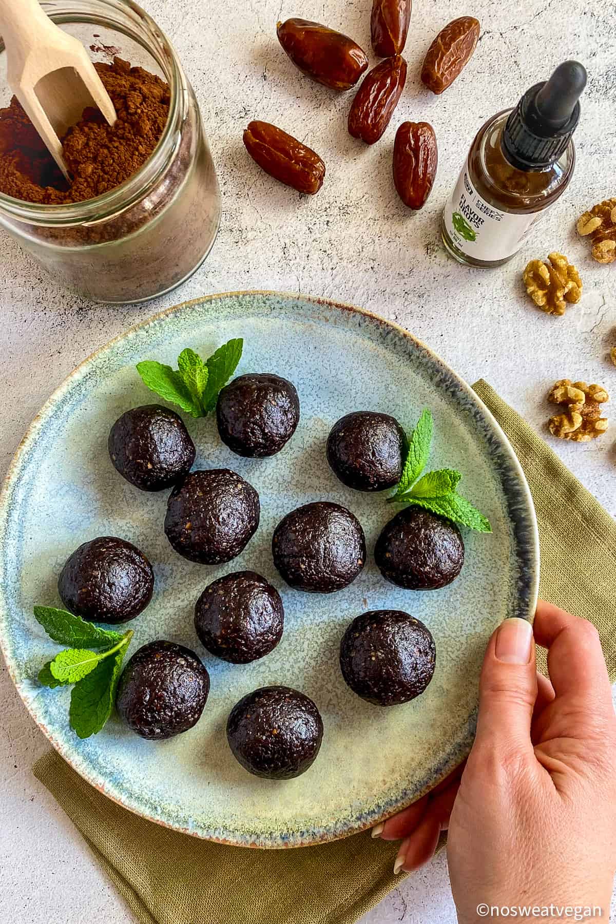 Thin Mint Bliss Balls on plate with mint leaves.