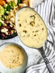 Hummus dressing on spoon close up.