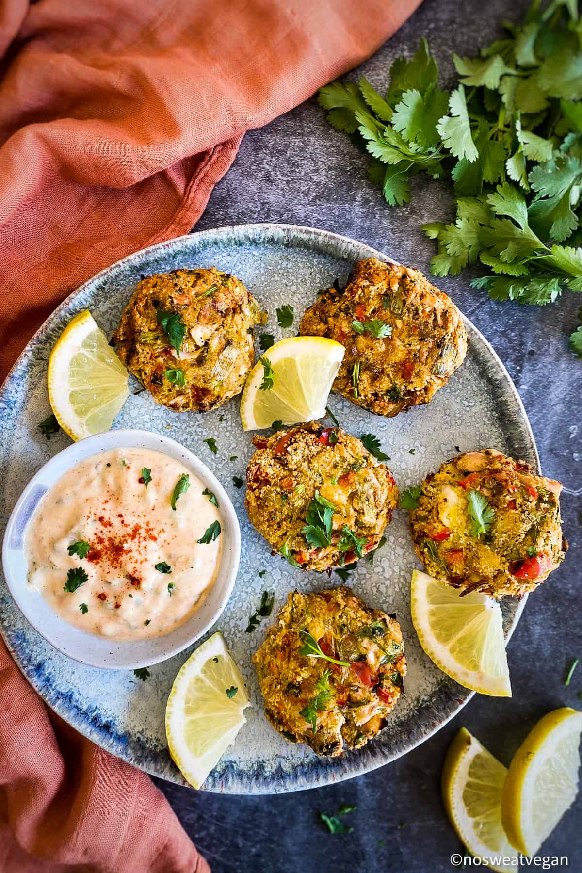 Vegan crab cakes on plate with remoulade sauce.