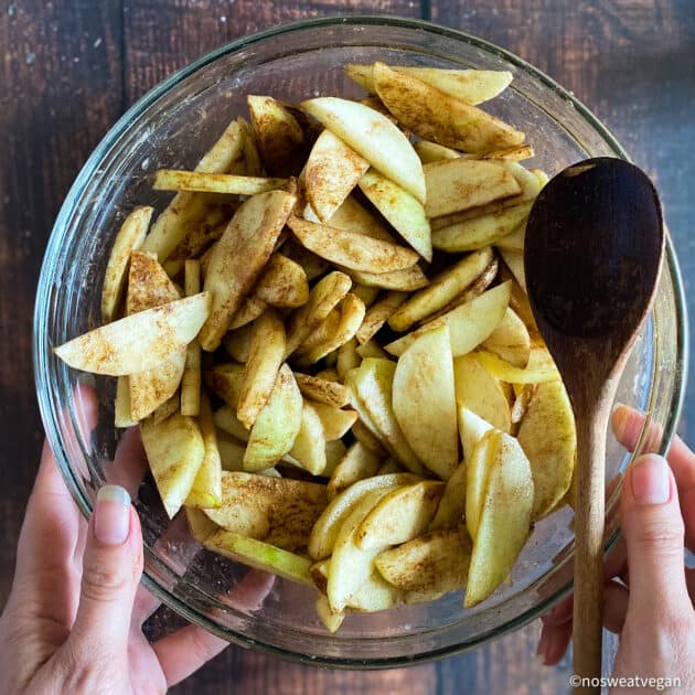 Apple slices mixed with seasonings.