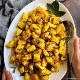 Air fryer butternut squash on plate with sage.
