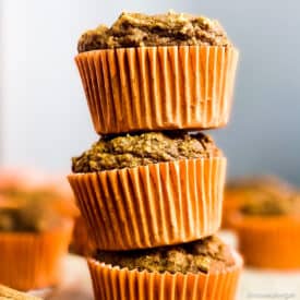 Healthy vegan pumpkin muffins stacked.