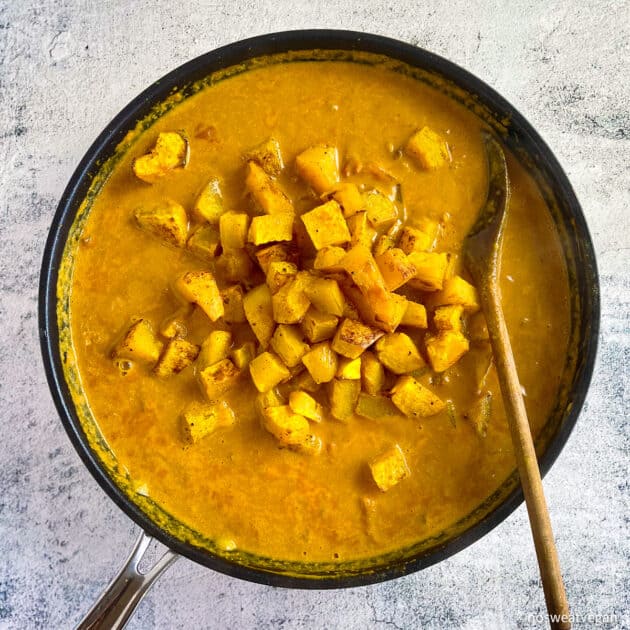 Add butternut squash to the chickpea curry.
