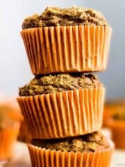 Healthy vegan pumpkin muffins stacked.