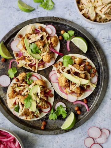 Cauliflower and chickpea tacos on a plate.