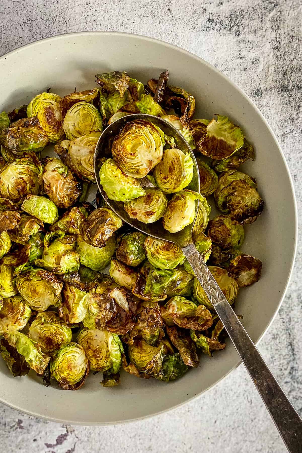 Brussel sprouts made in the air fryer in a bowl.