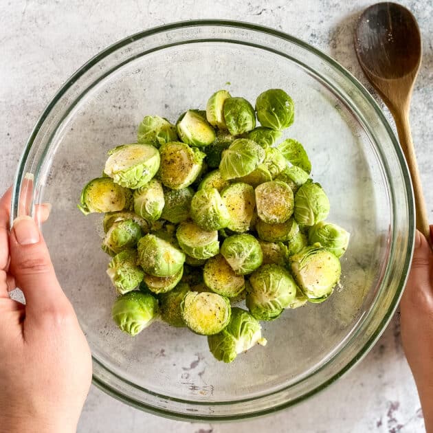 Brussels sprouts in a bowl with seasonings.
