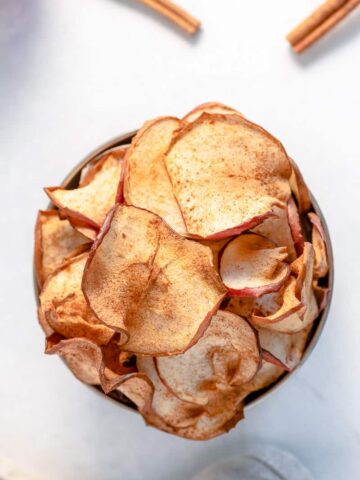 Air Fryer apple chips in bowl.