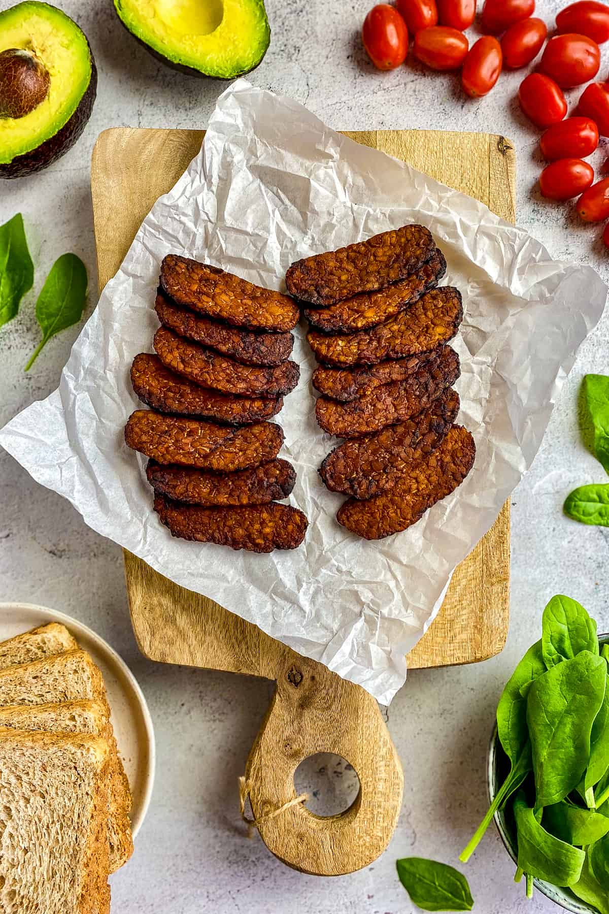 Air fryer tempeh bacon on cutting board.