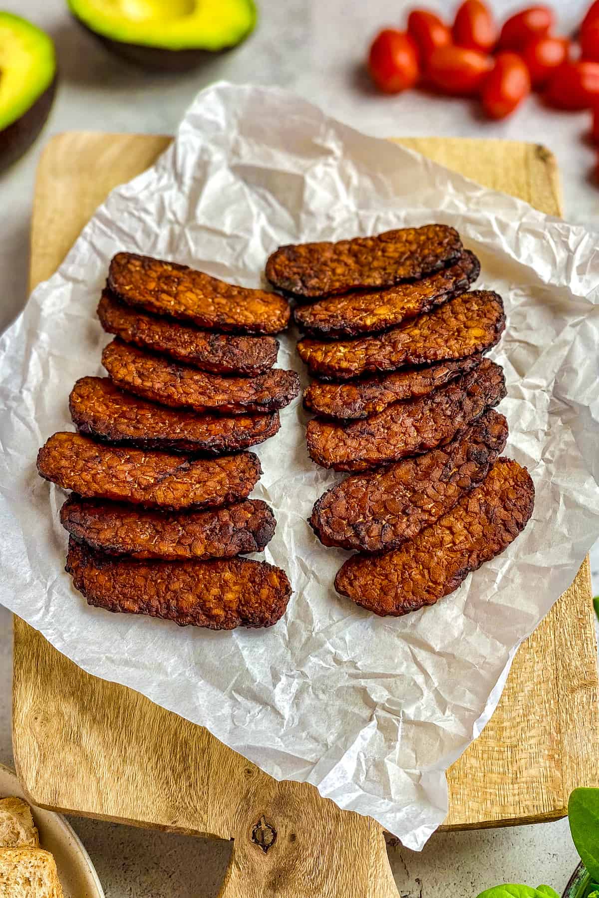 Air fried tempeh on a cutting board.