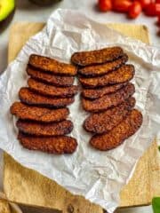 Air fried tempeh on a cutting board.
