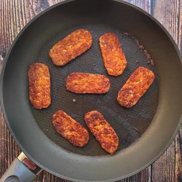 Tempeh bacon in skillet.