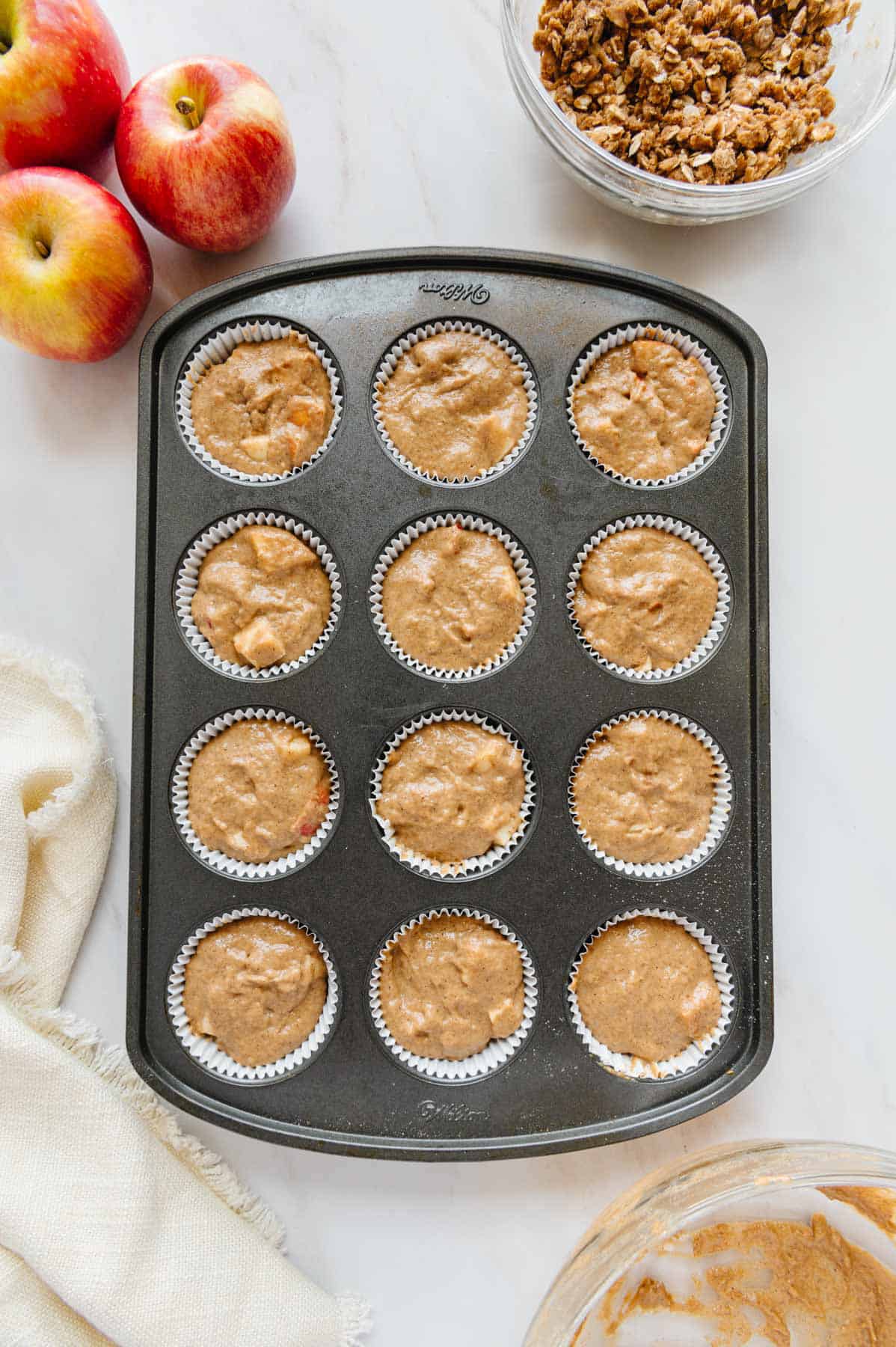 Vegan apple muffin batter in tray.