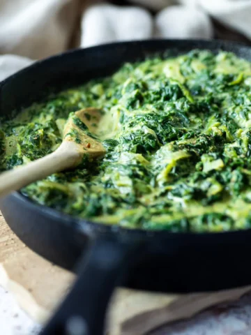 Vegan creamed spinach in a cast iron skillet.