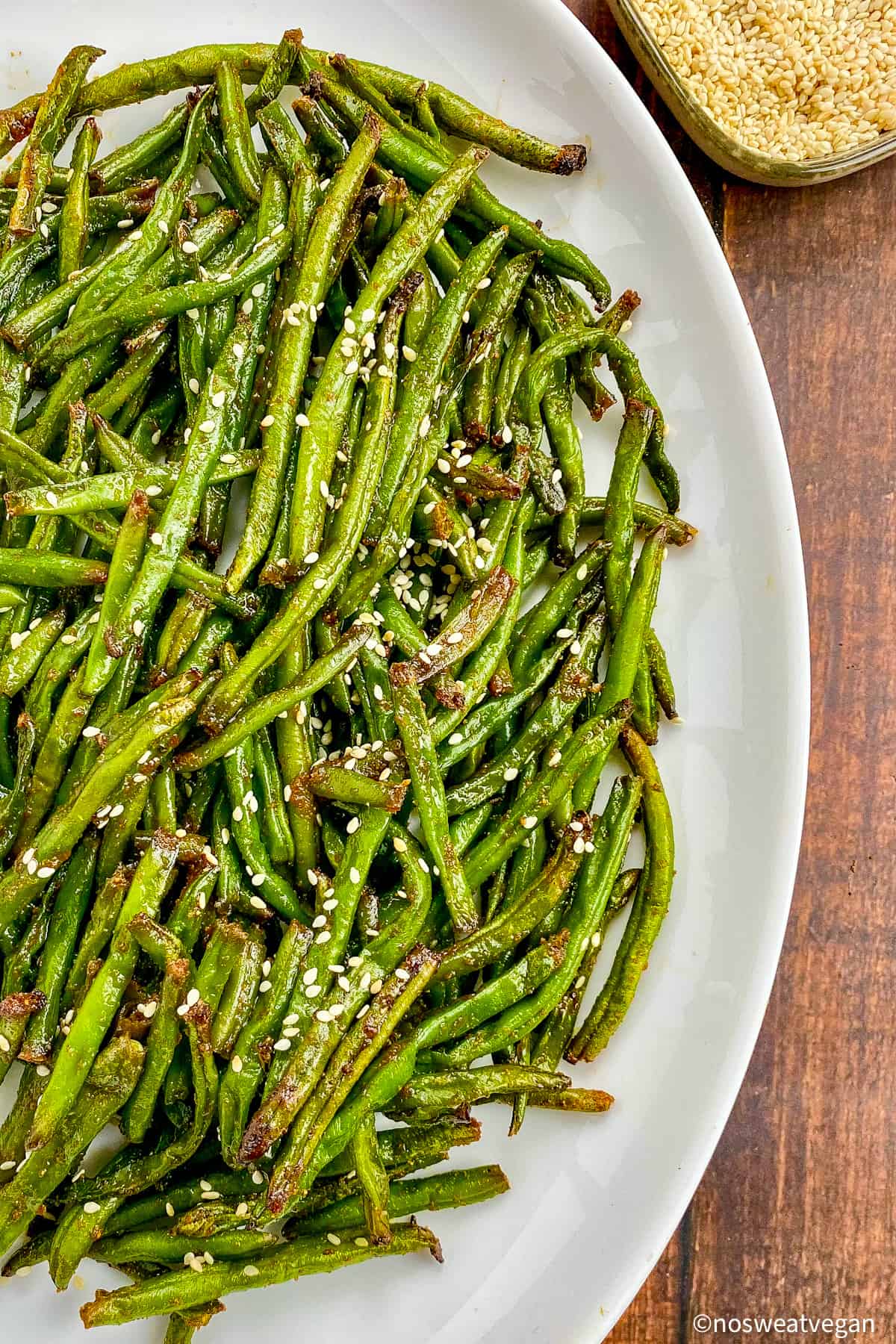Frozen green beans cooked in air fryer on a plate.
