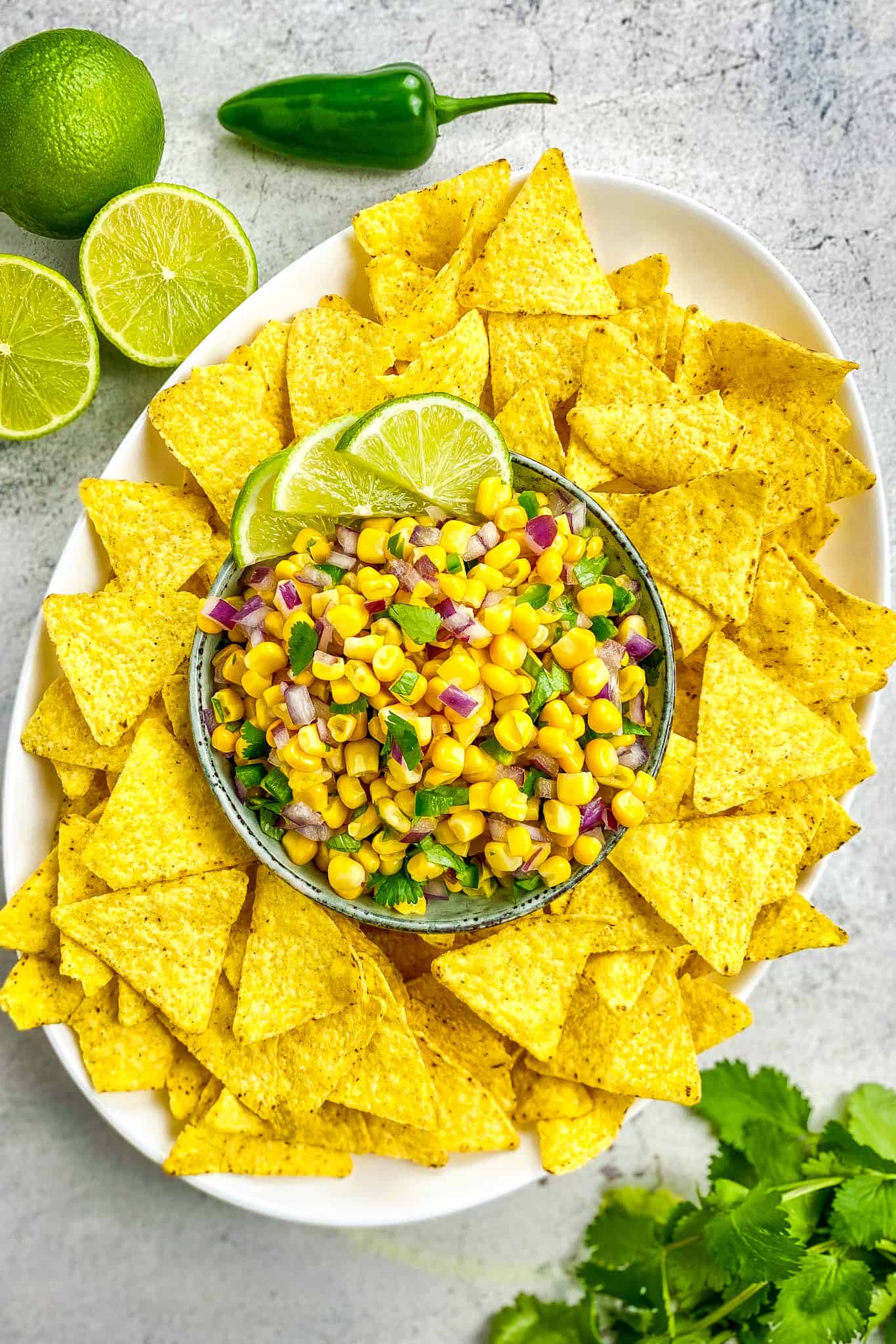 Chipotle corn salsa in a bowl surrounded by chips.