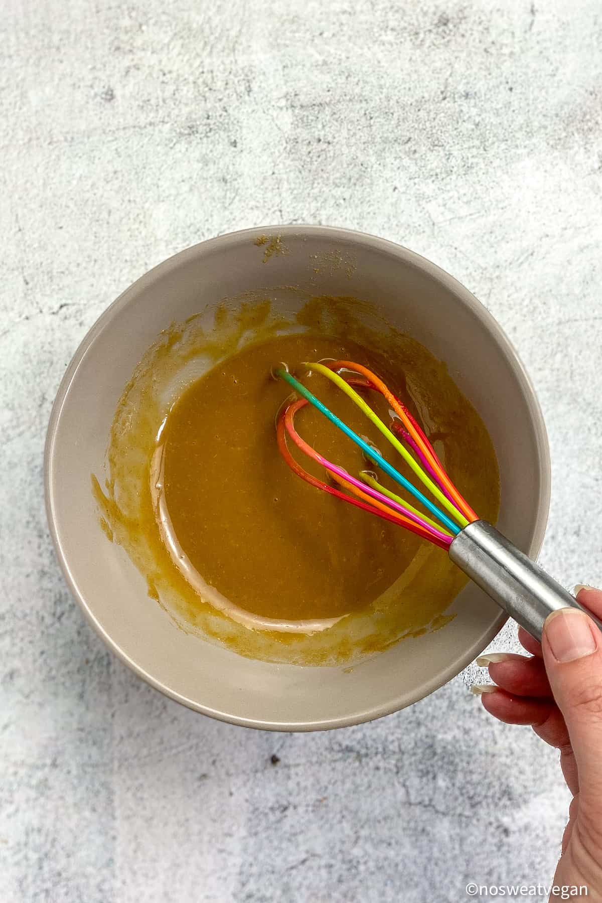 Tahini ginger dressing mixed in a bowl.