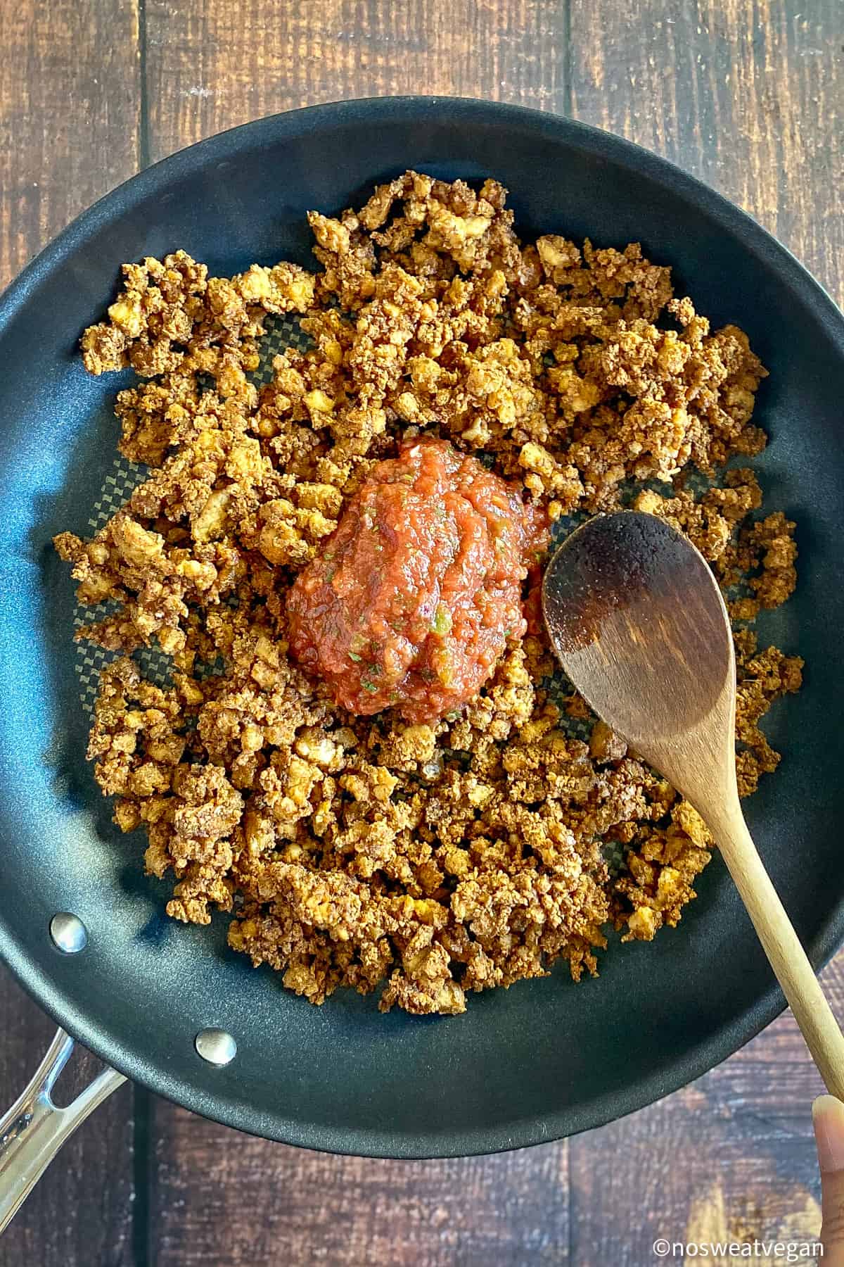 Tofu taco meat in a skillet with salsa.