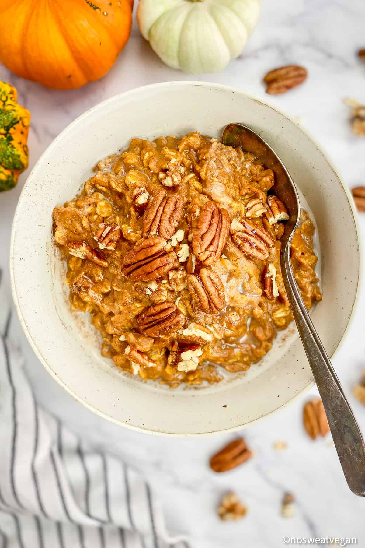Pumpkin oatmeal in a bowl with a spoon.
