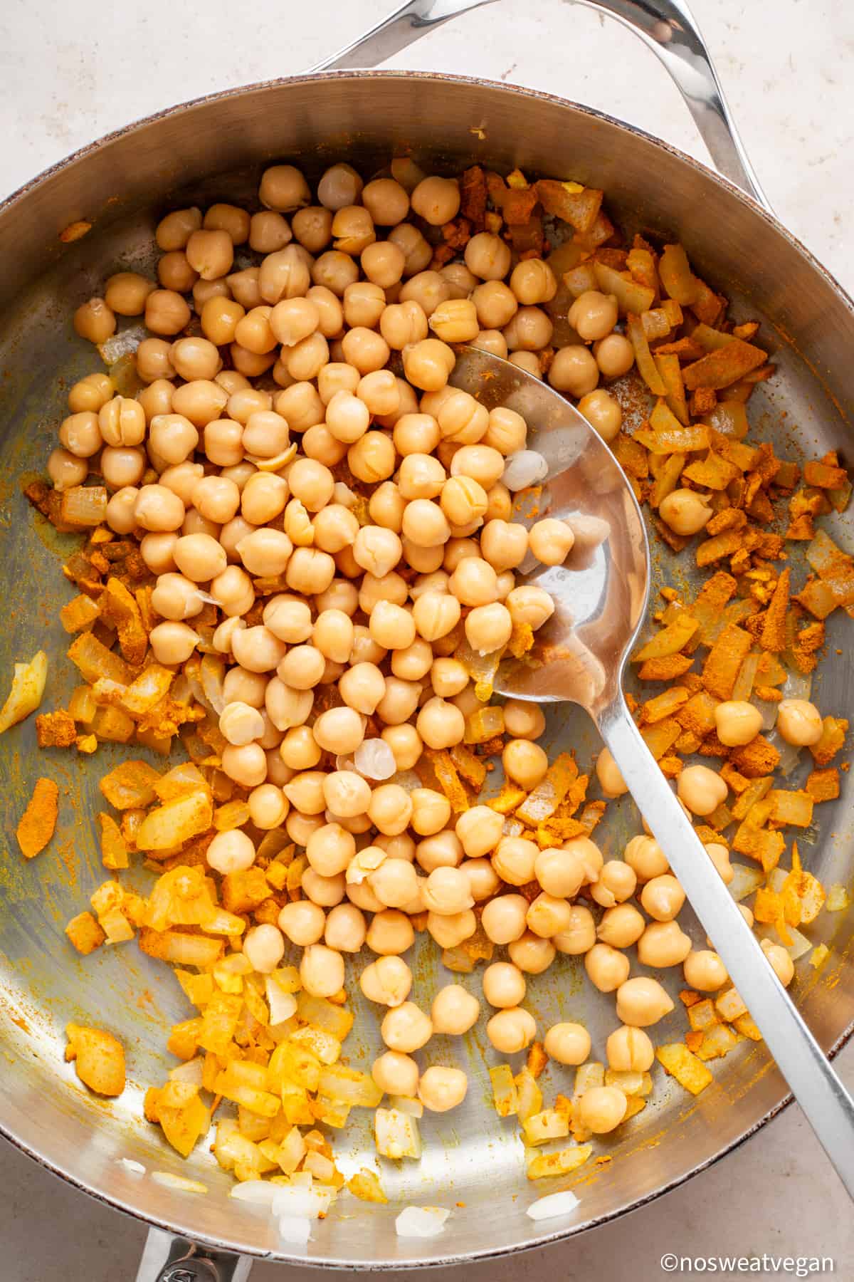 Chickpeas added to curry.