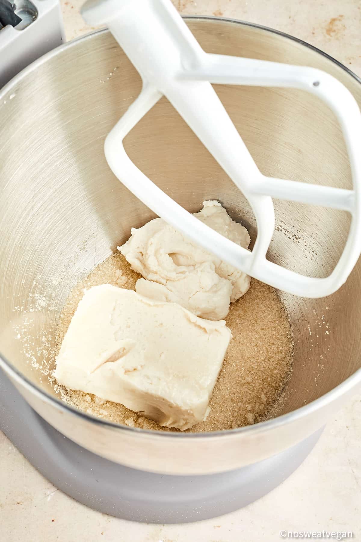 Sugar, butter, and cream cheese in a mixer.