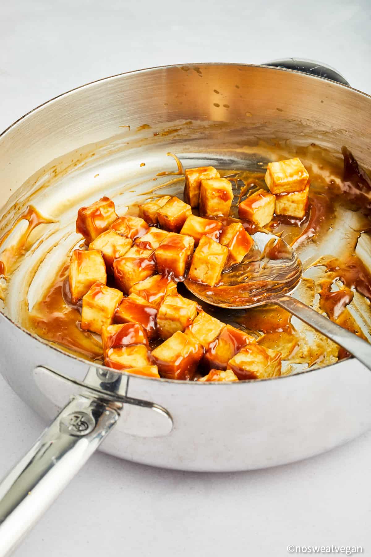 Tofu cooking in a skillet.